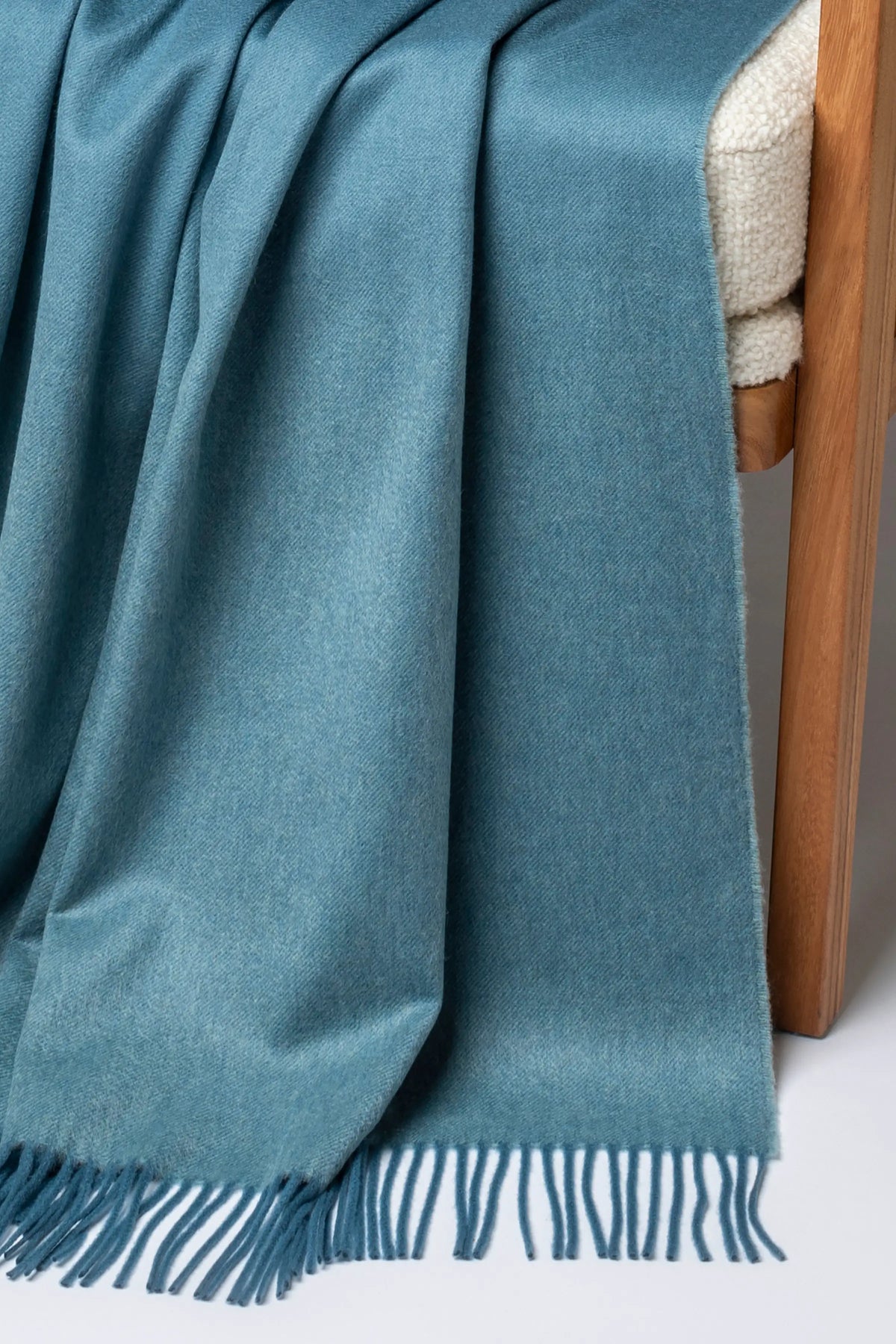 2025 Johnstons of Elgin Interiors Collection Seascape & Navy Ombré Cashmere Throw on a grey background WA000055RU7686ONE