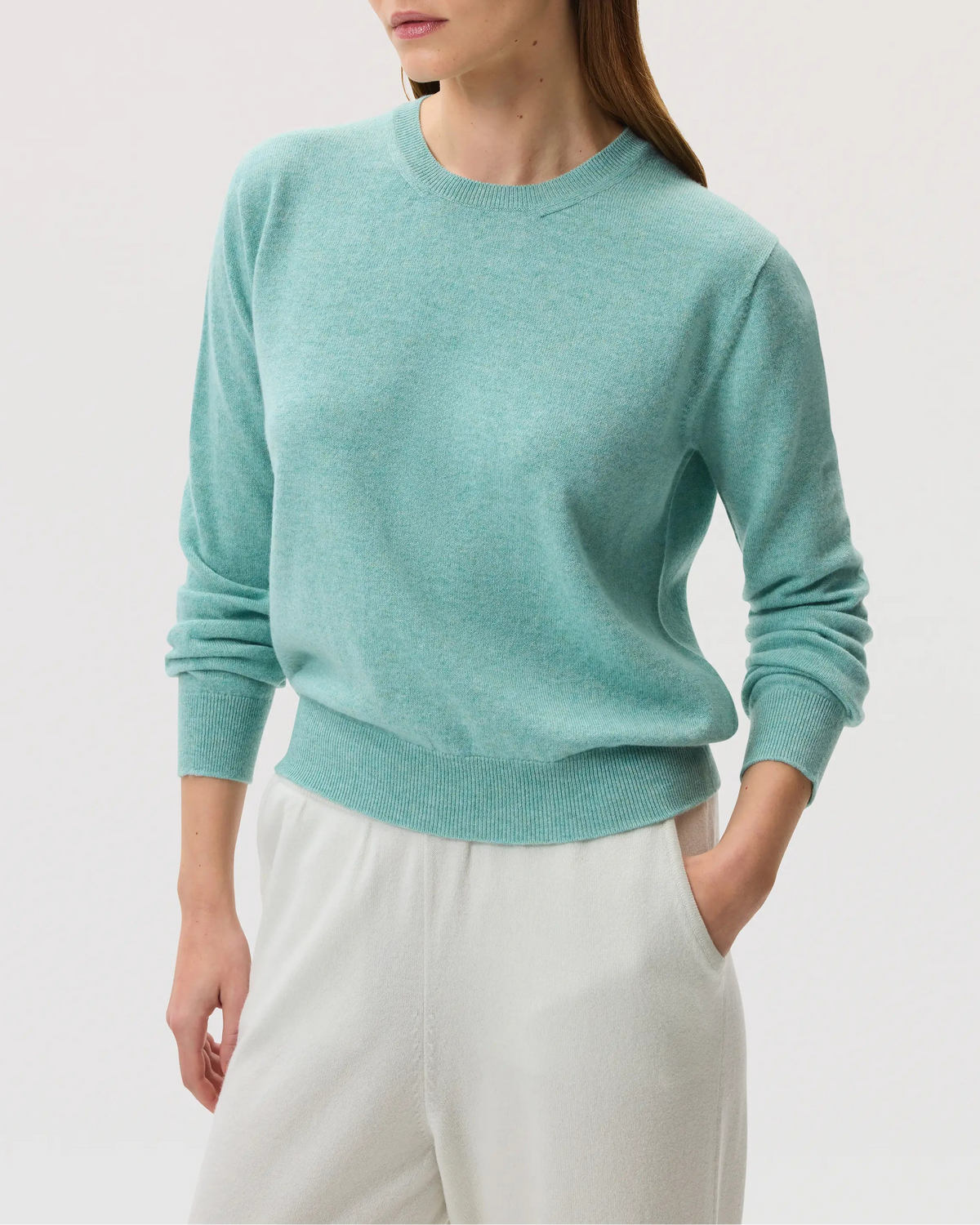 Model wearing Johnstons of Elgin SS25 Women's Knitwear Jade Classic Cashmere Round Neck jumper against a white backdrop KAI05142HC4284