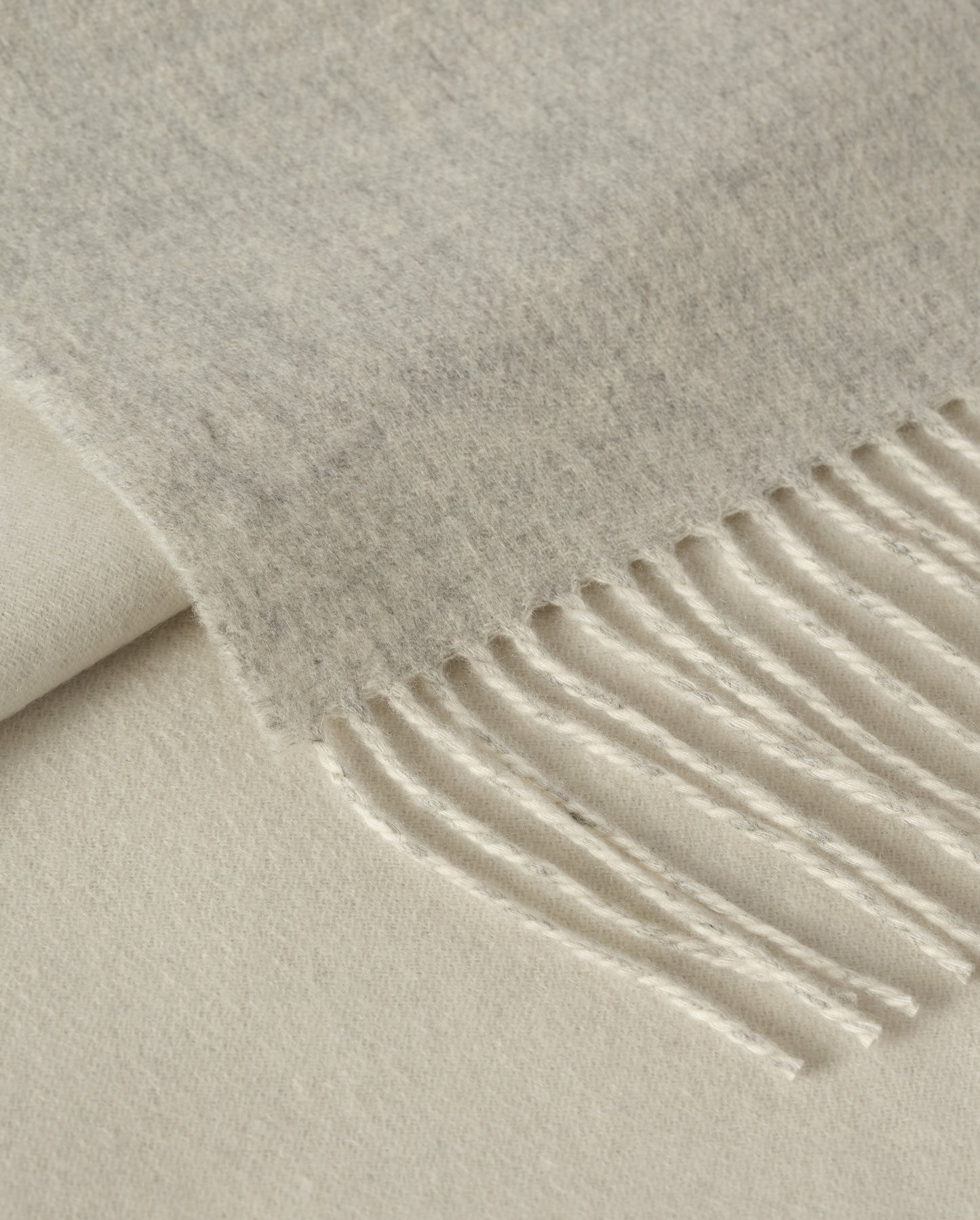Johnstons of Elgin Interiors Collection Silver & White Reversible Cashmere Bed Throw on a white background WA001374RU6322ONE