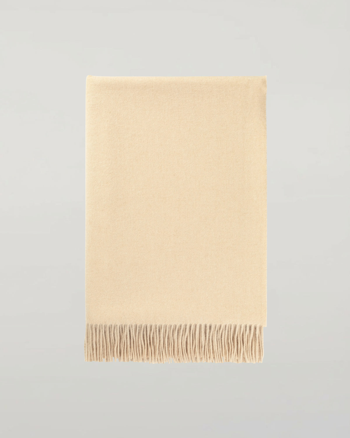 Johnstons of Elgin Interiors Collection Blonde Blonde Cashmere Throw on a grey background WA000055HB0167ONE