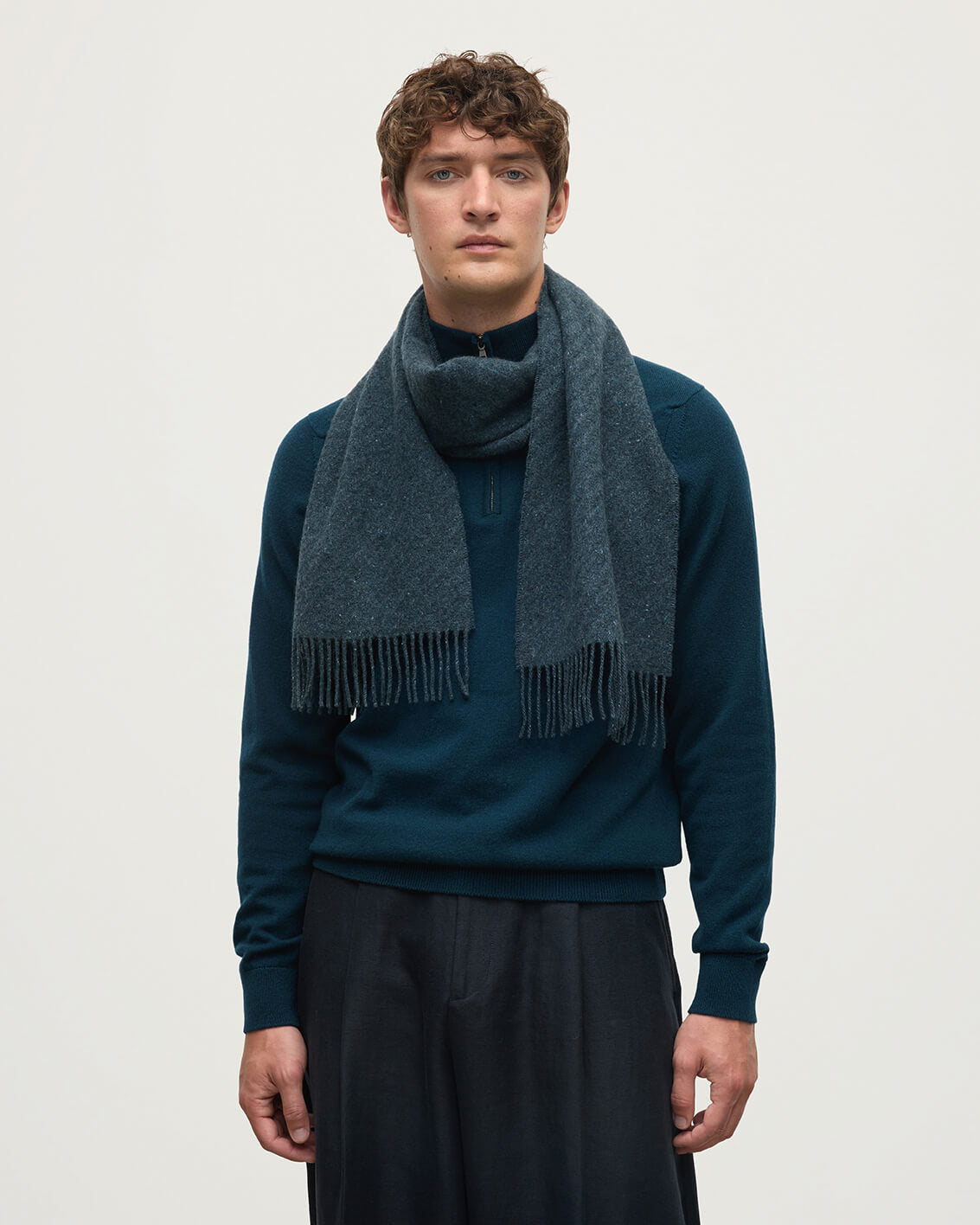 Model wears Johnstons of Elgin Woven Accessories Storm Lofty Twill Blue Cashmere Scarf WAC02307RU7657ONE