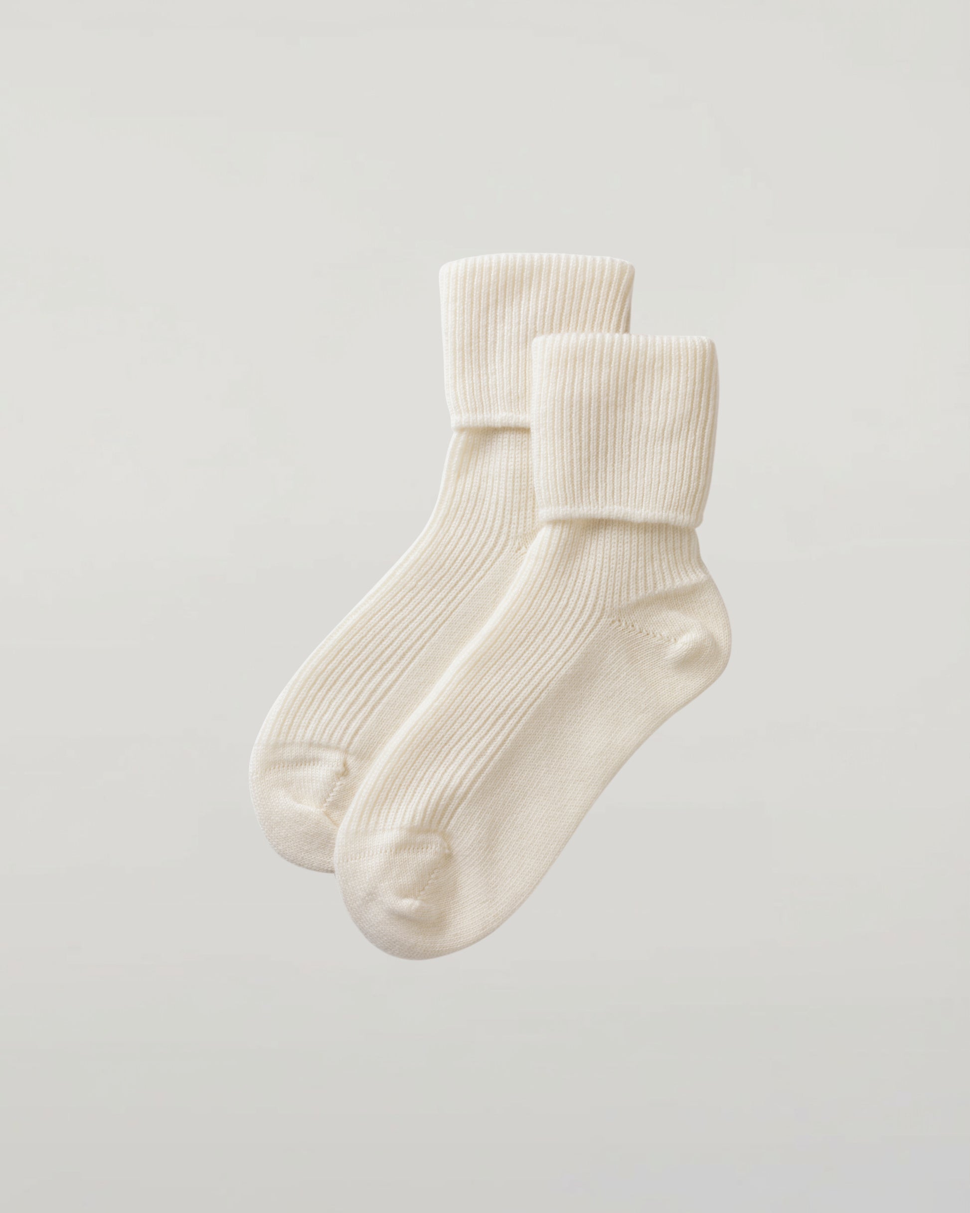 Johnstons of Elgin set of three pairs of cashmere socks in pastel colours on a light grey background 2025GIFTSET3A
