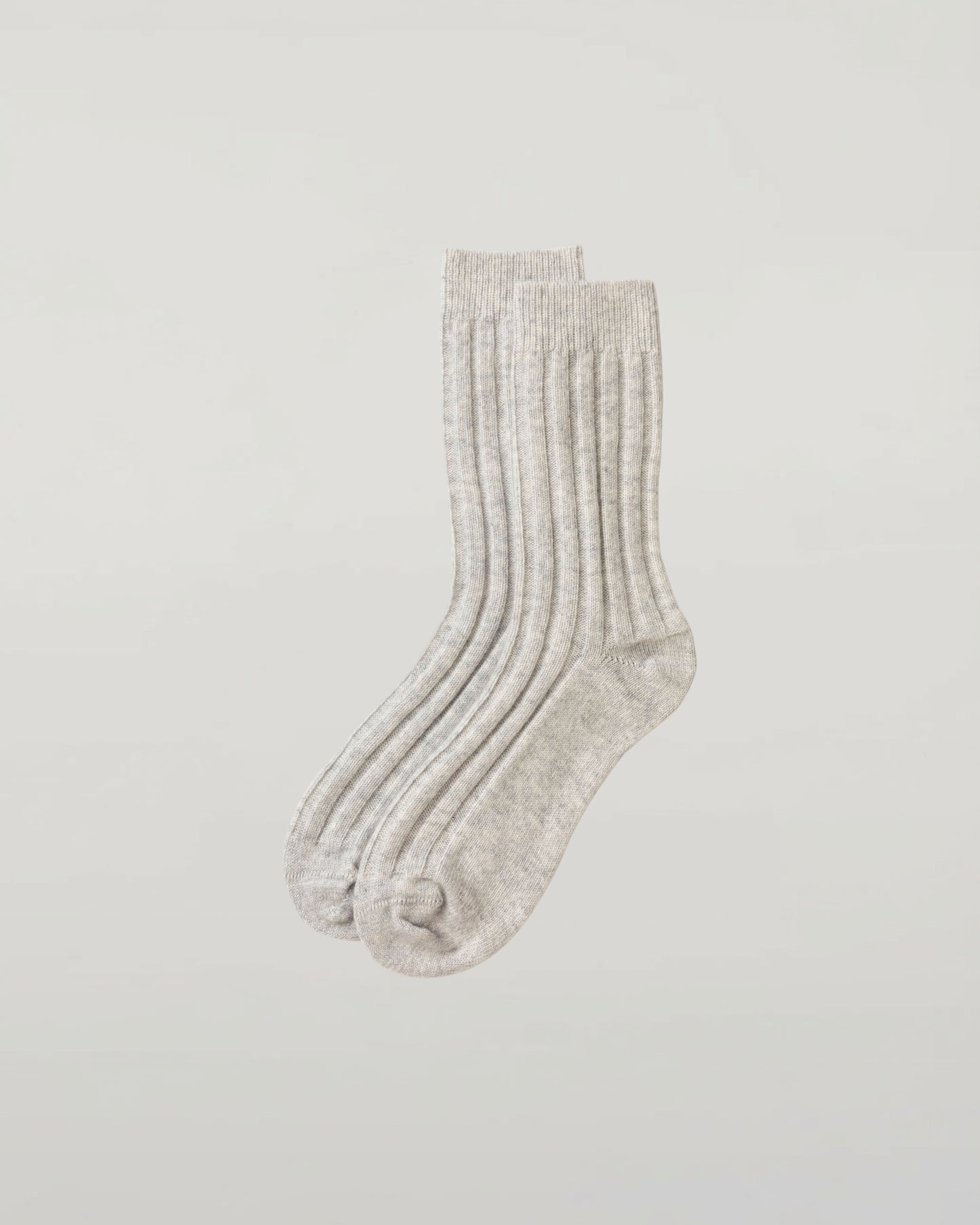 Johnstons of Elgin set of three pairs of cashmere socks in navy, light grey, and mid grey on a light grey background 2025GIFTSET4A