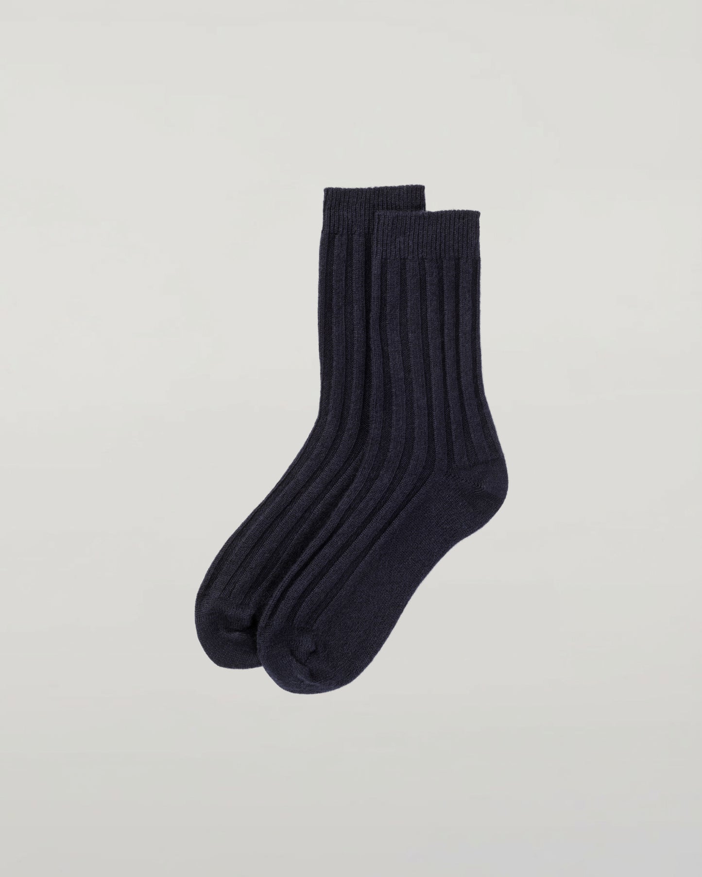 Johnstons of Elgin set of three pairs of cashmere socks in navy, light grey, and mid grey on a light grey background 2025GIFTSET4A