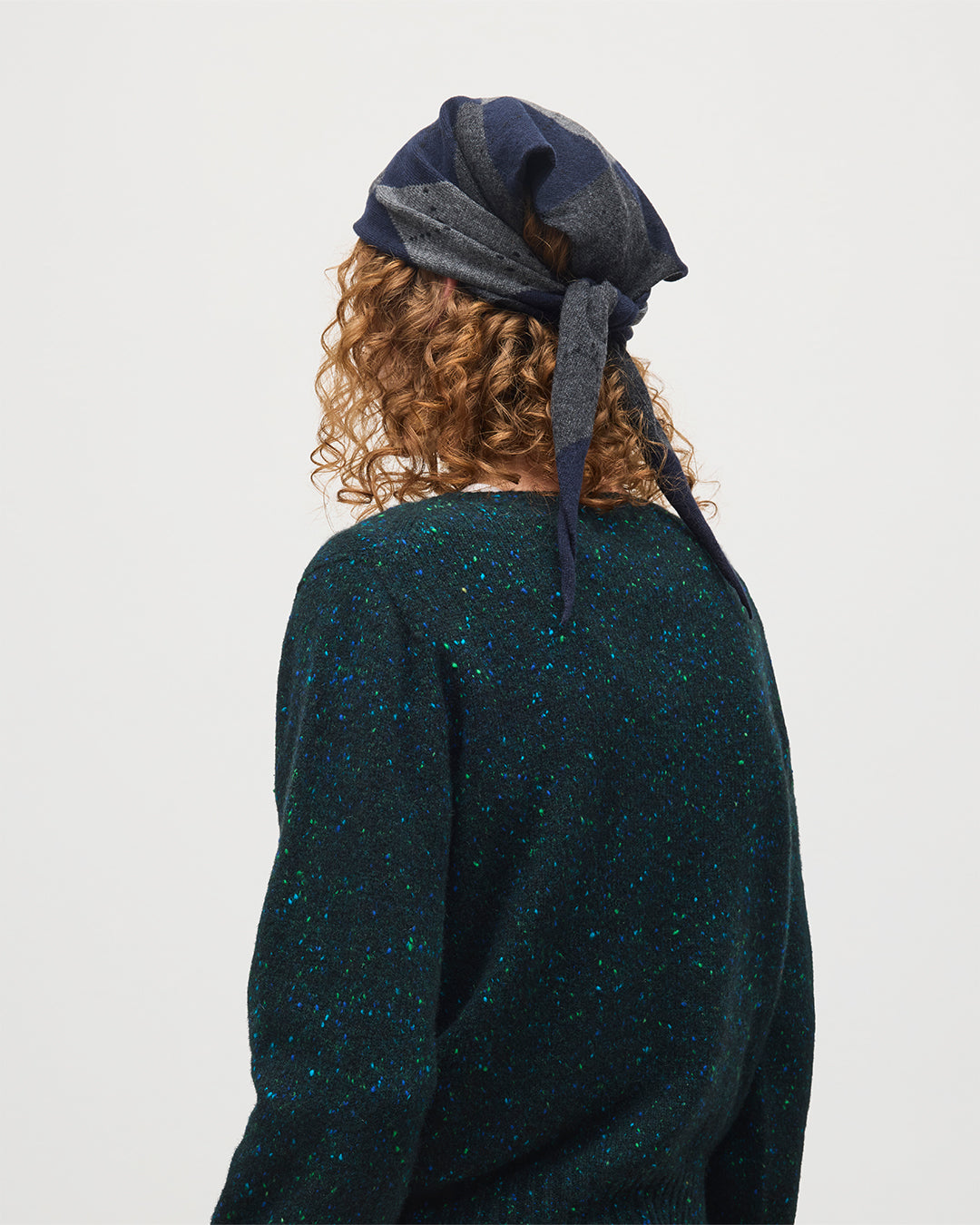 FEMALE MODEL WEARING JOHNSTONS OF ELGIN CLAN BANDANA NAVY 100% CASHMERE ON A MALE MODEL OVER A FIR DONEGAL CAIRN CASHMERE SWEATER HAP03612JU1613ONE