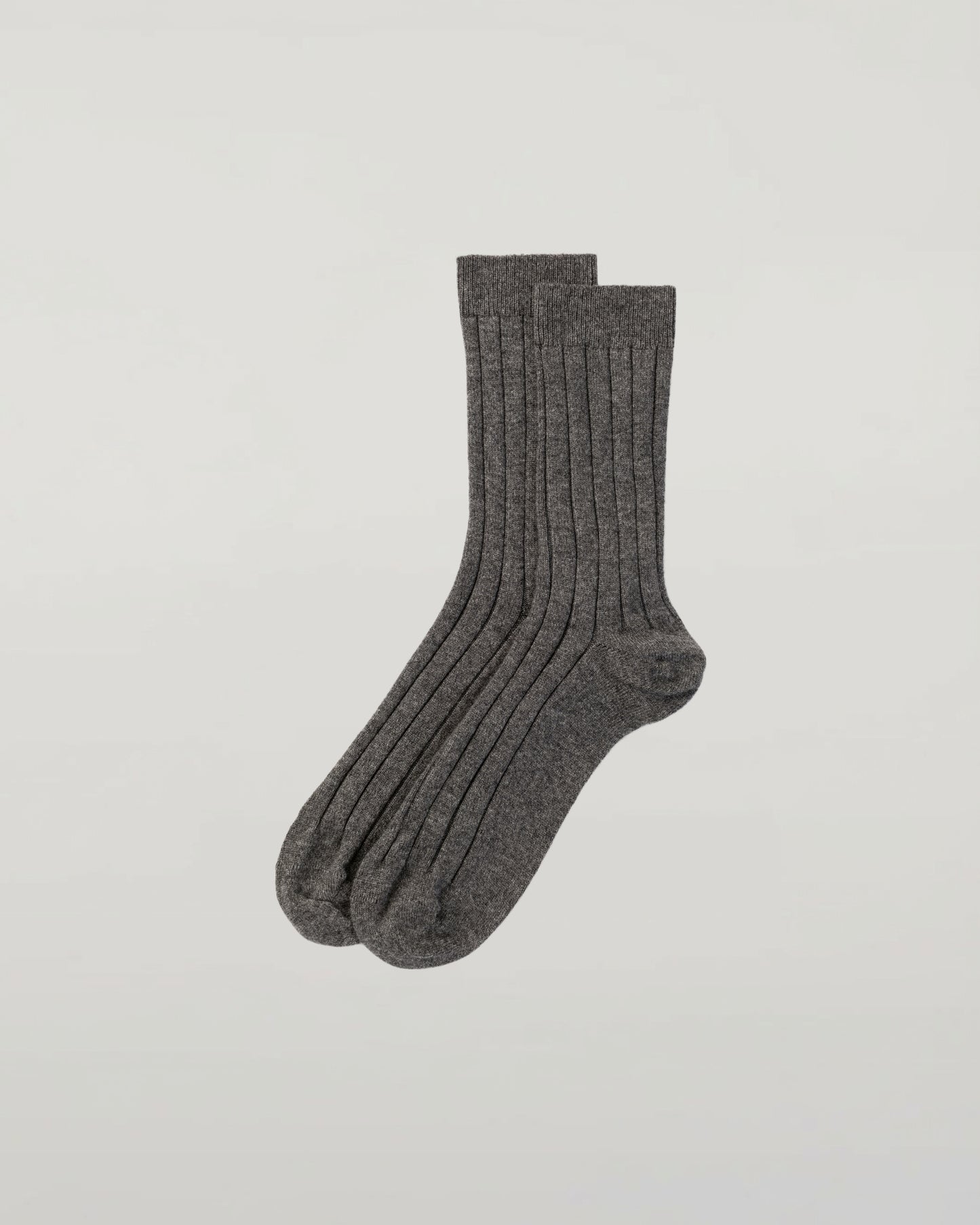 Johnstons of Elgin set of three pairs of cashmere socks in grey, navy, and beige on a light grey background 2025GIFTSET2