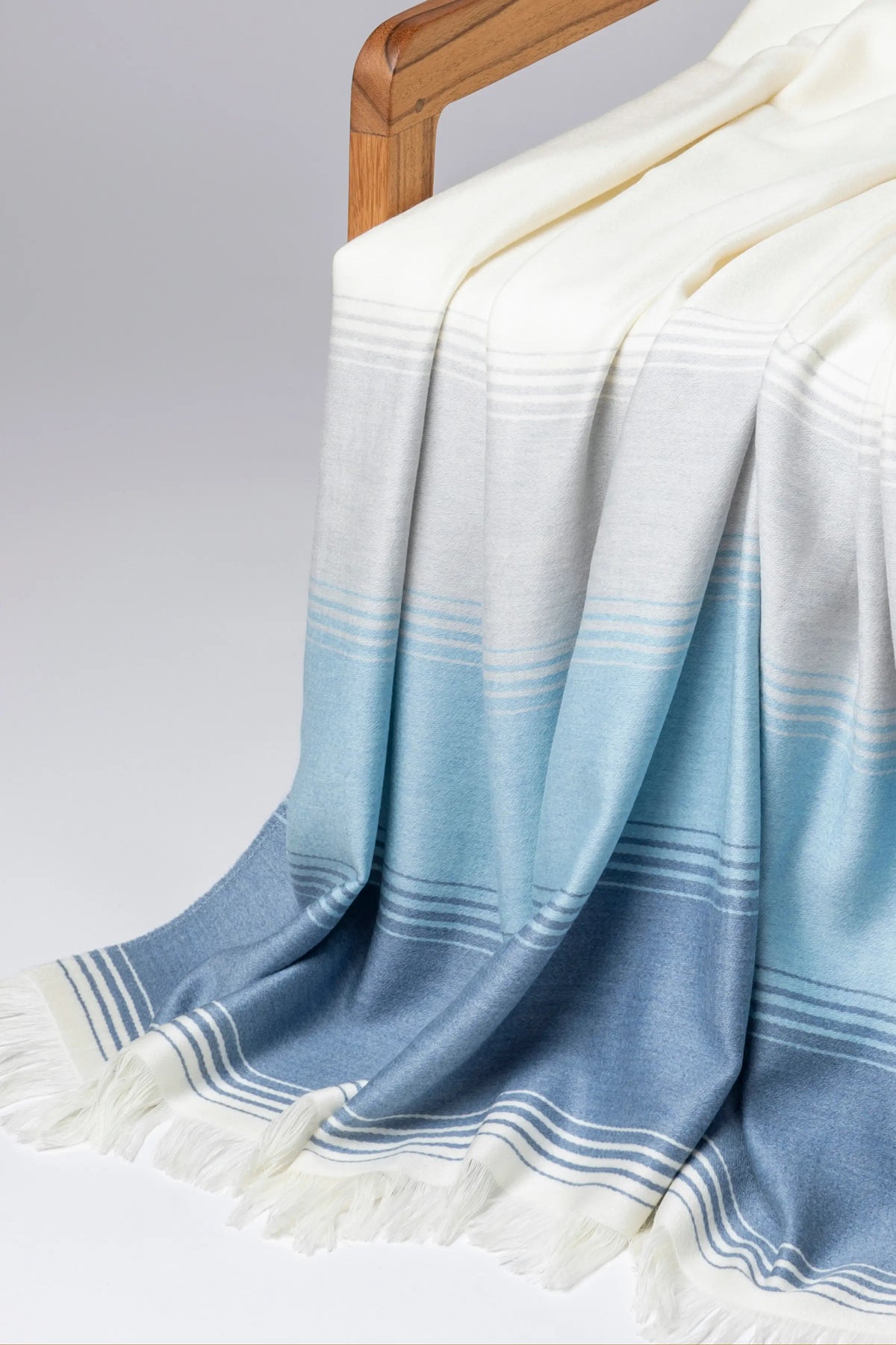 2025 Johnstons of Elgin Interiors Collection Green & Blue Diffused Stripe Merino Wool Throw on a grey background  WD000257RU7611ONE