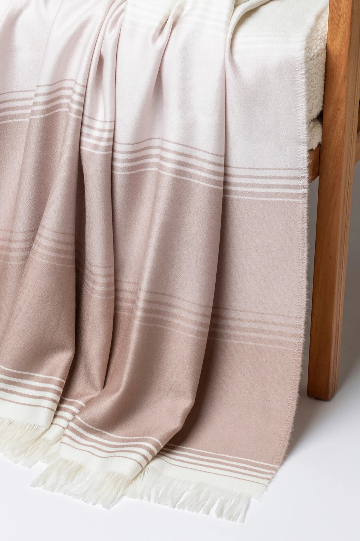 2025 Johnstons of Elgin Interiors Collection Camel & Pink Diffused Stripe Merino Wool Throw on a grey background  WD000257RU7610ONE