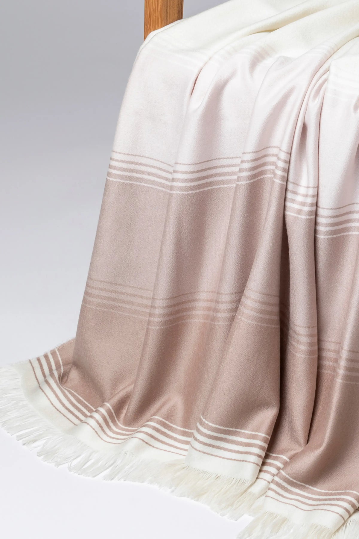 2025 Johnstons of Elgin Interiors Collection Camel & Pink Diffused Stripe Merino Wool Throw on a grey background  WD000257RU7610ONE