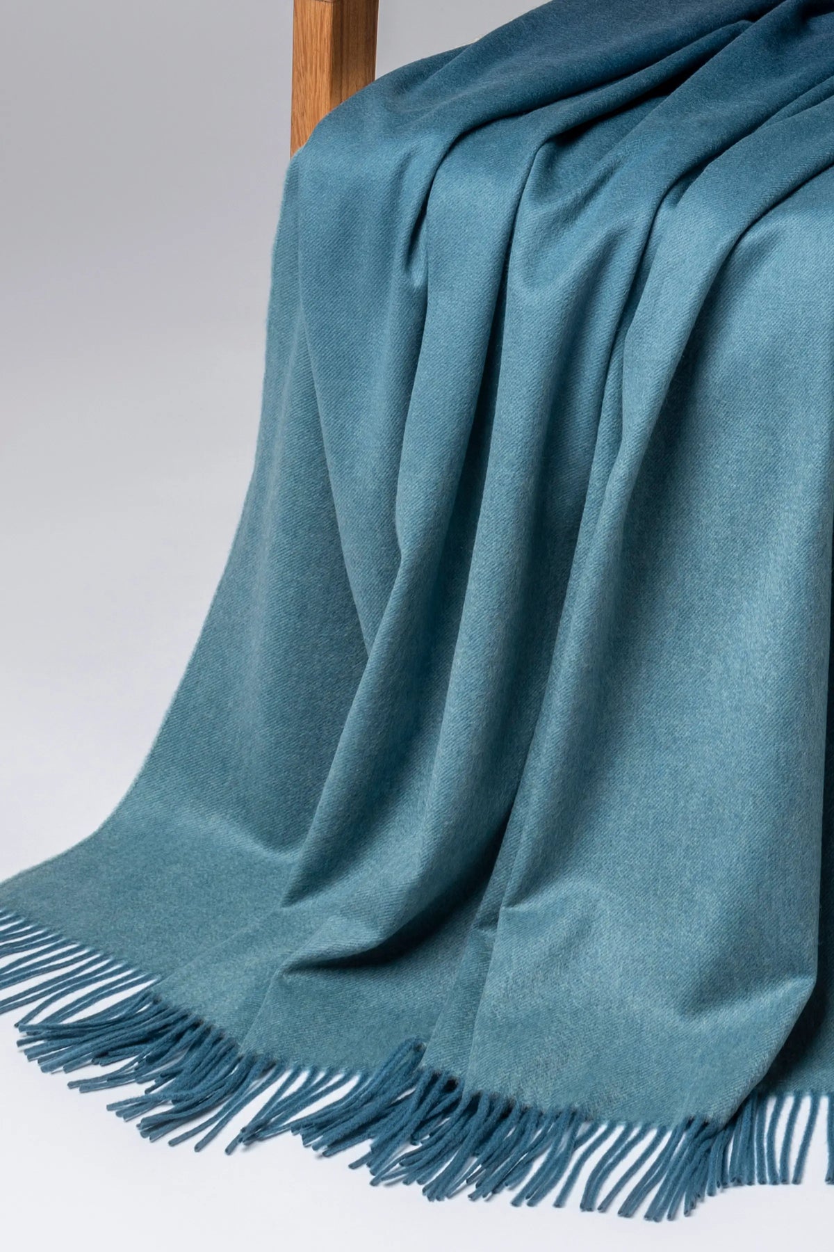 2025 Johnstons of Elgin Interiors Collection Seascape & Navy Ombré Cashmere Throw on a grey background  WA000055RU7686ONE