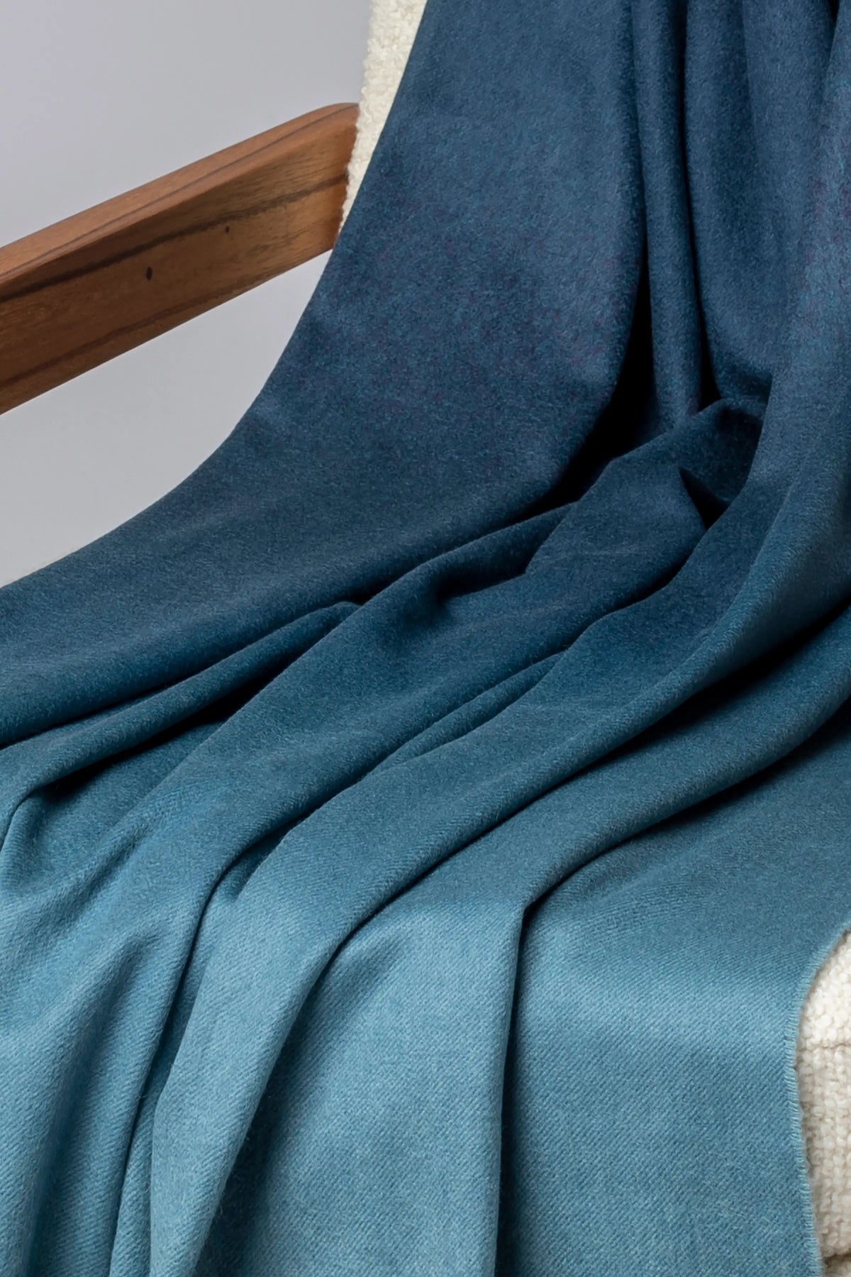 2025 Johnstons of Elgin Interiors Collection Seascape & Navy Ombré Cashmere Throw on a grey background  WA000055RU7686ONE