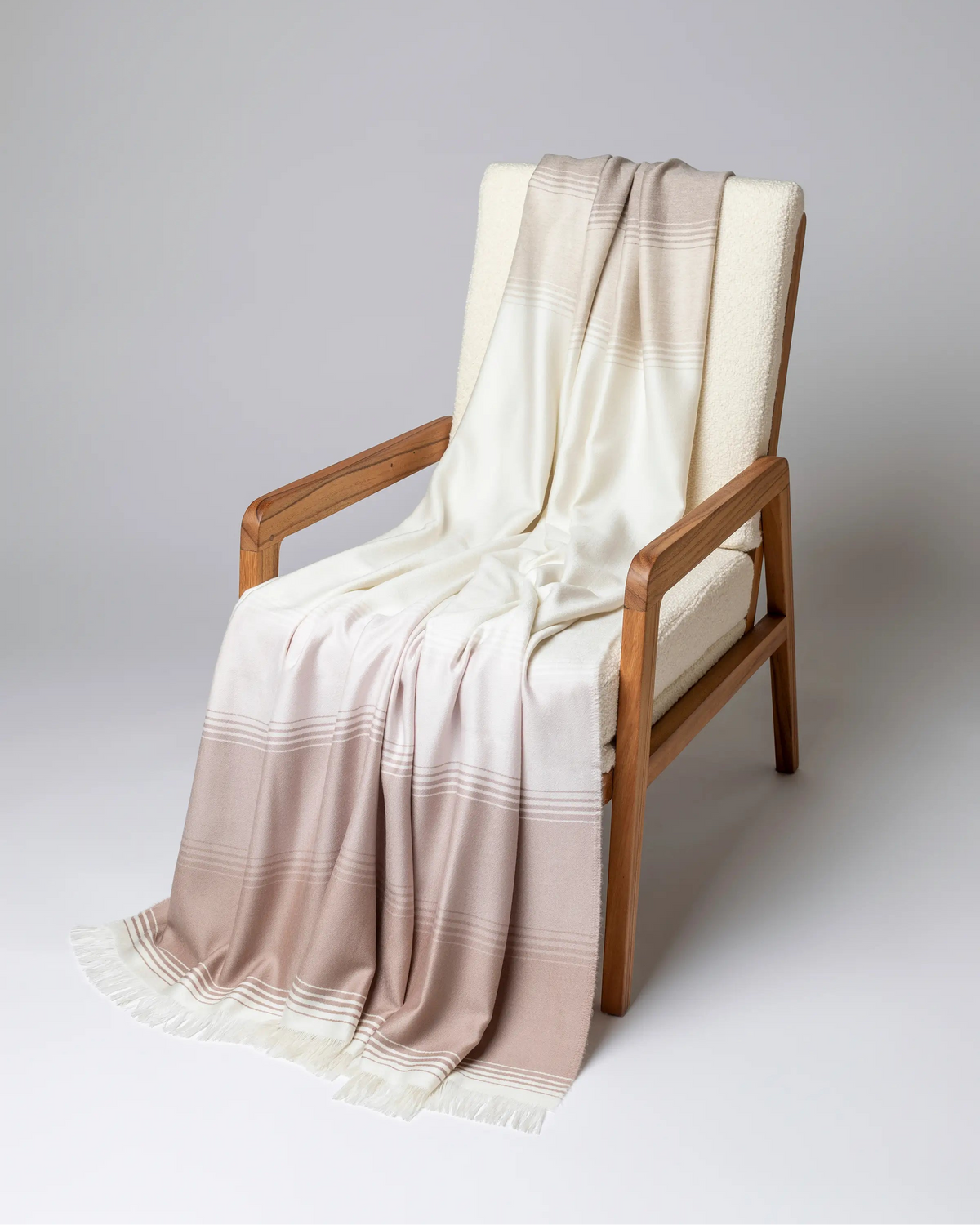 2025 Johnstons of Elgin Interiors Collection Camel & Pink Diffused Stripe Merino Wool Throw on a grey background  WD000257RU7610ONE