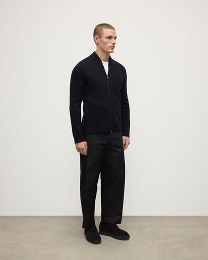 Side view of a model wearing Johnstons of Elgin Men's Knitwear Black Milano Ribbed Zip Black Cashmere  KAA05443SA7210