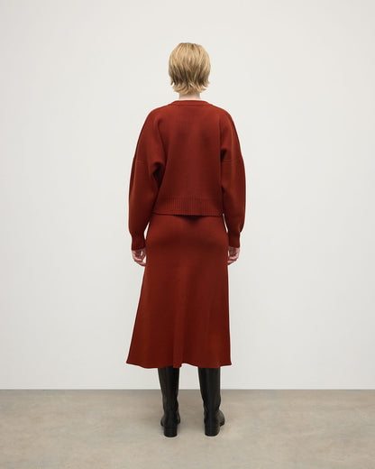 Model wearing Johnstons of Elgin AW25 Women's Knitwear Oxblood Cropped Milano Red Cashmere Jumper Back View KAA05488SG4463