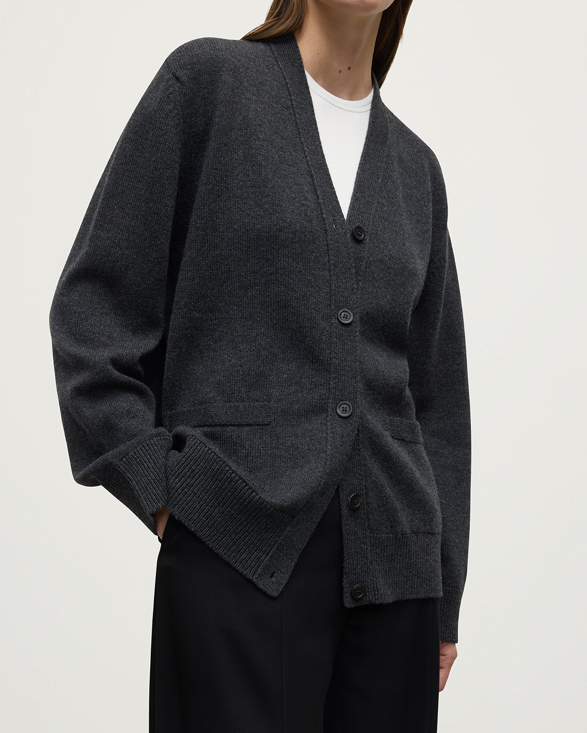 Model wearing Johnstons of Elgin AW25 Women's Knitwear Charcoal Boyfriend-Fit Grey Cashmere Cardigan close up KAA05560HA7165