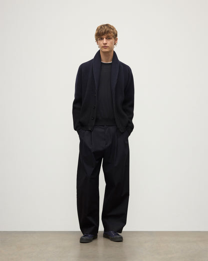 MALE MODEL WEARING JOHNSTONS OF ELGIN PIONEER SHAWL CARDIGAN NAVY & BLACK 100% CASHMERE WITH BLACK SUPERFINE CASHMERE SWEATER AND NAVY TROUSERS KAA05750Q25947