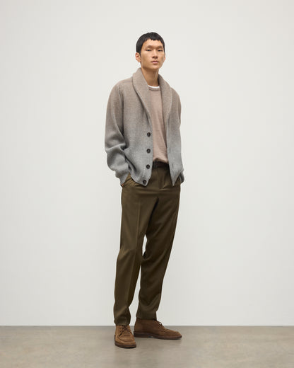 MALE MODEL WEARING JOHNSTONS OF ELGIN PIONEER SHAWL CARDIGAN GREY 100% CASHMERE WITH OLIVE GREEN CHINOS, OVER A SUPERFINE CASHMERE LIGHT BROWN SWEATER AND WHITE T-SHIRT KAA05750Q25948