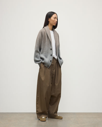 FEMALE MODEL WEARING JOHNSTONS OF ELGIN PIONEER SHAWL CARDIGAN GREY 100% CASHMERE WITH BROWN WIDE LEG CHINOS, WHITE T-SHIRT & TRAINERS UAA05750Q25948