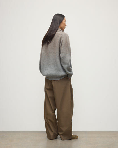 BACK OF FEMALE MODEL WEARING JOHNSTONS OF ELGIN PIONEER SHAWL CARDIGAN GREY 100% CASHMERE WITH BROWN WIDE LEG CHINOS, WHITE T-SHIRT & TRAINERS UAA05750Q25948