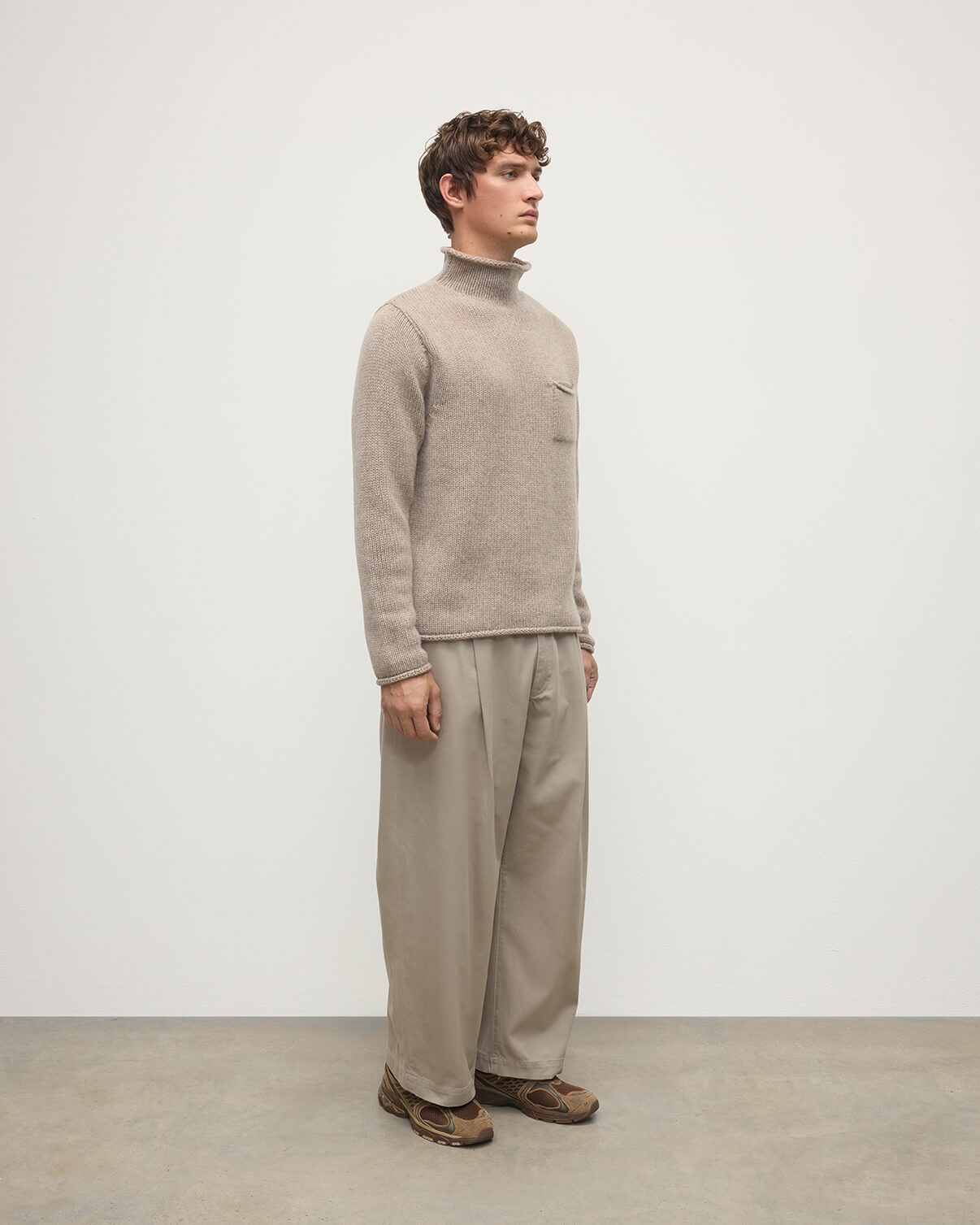 Model wearing Johnstons of Elgin  Men's Knitwear Ash Brown Cashmere Turtleneck Jumper Side KAB05484HB4334
