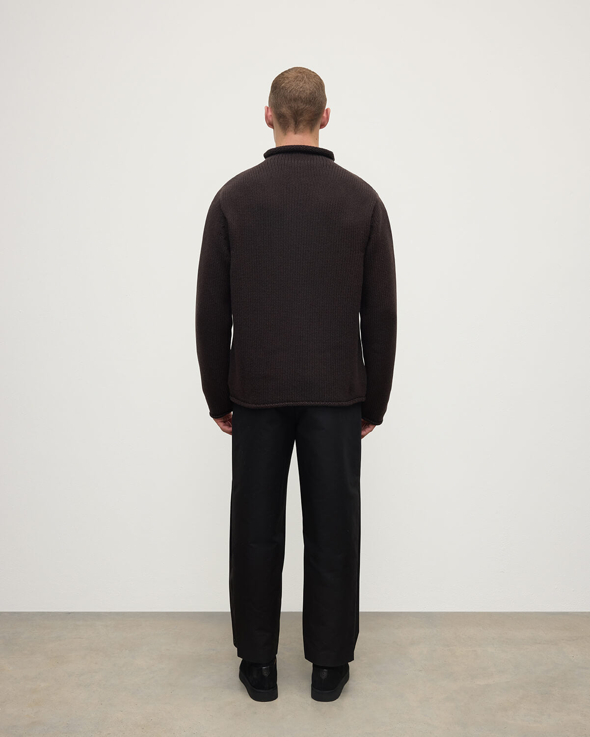 Back view of a model wearing Johnstons of Elgin AW25 Men's Knitwear Molasses Brown Cashmere Turtleneck Jumper KAB05484SB7290