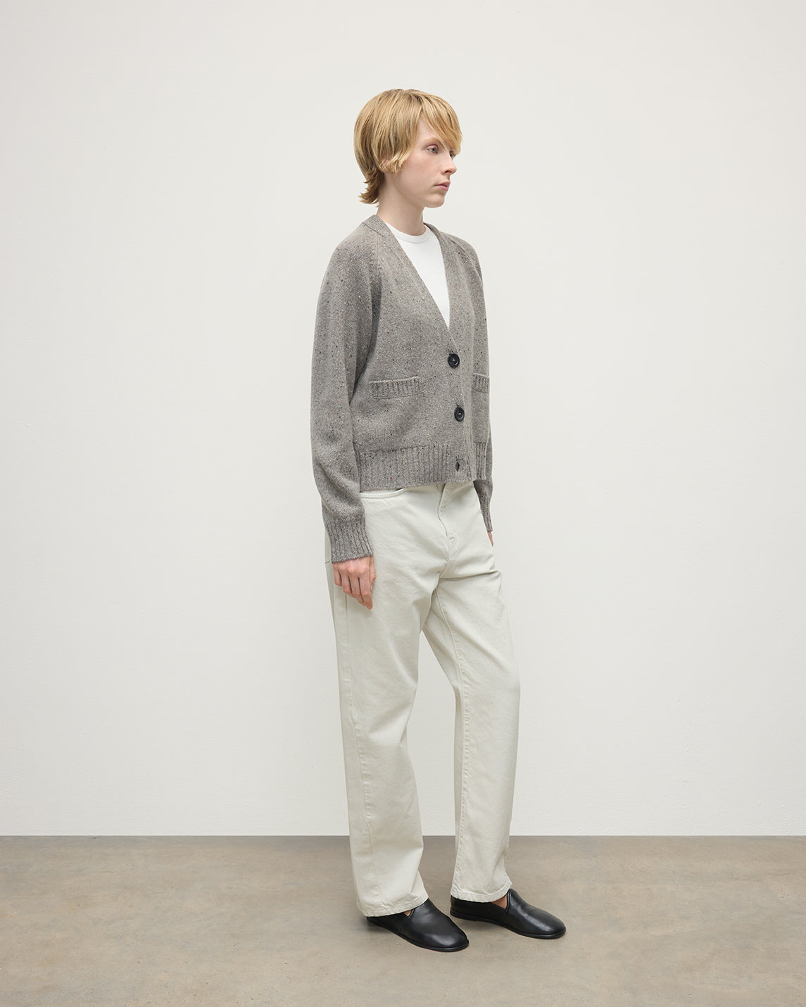 Model wearing Johnstons of Elgin AW25 Women's Knitwear Peregrine Donegal Donegal Cashmere Grey V Neck Cardigan Side View KAC05090006335