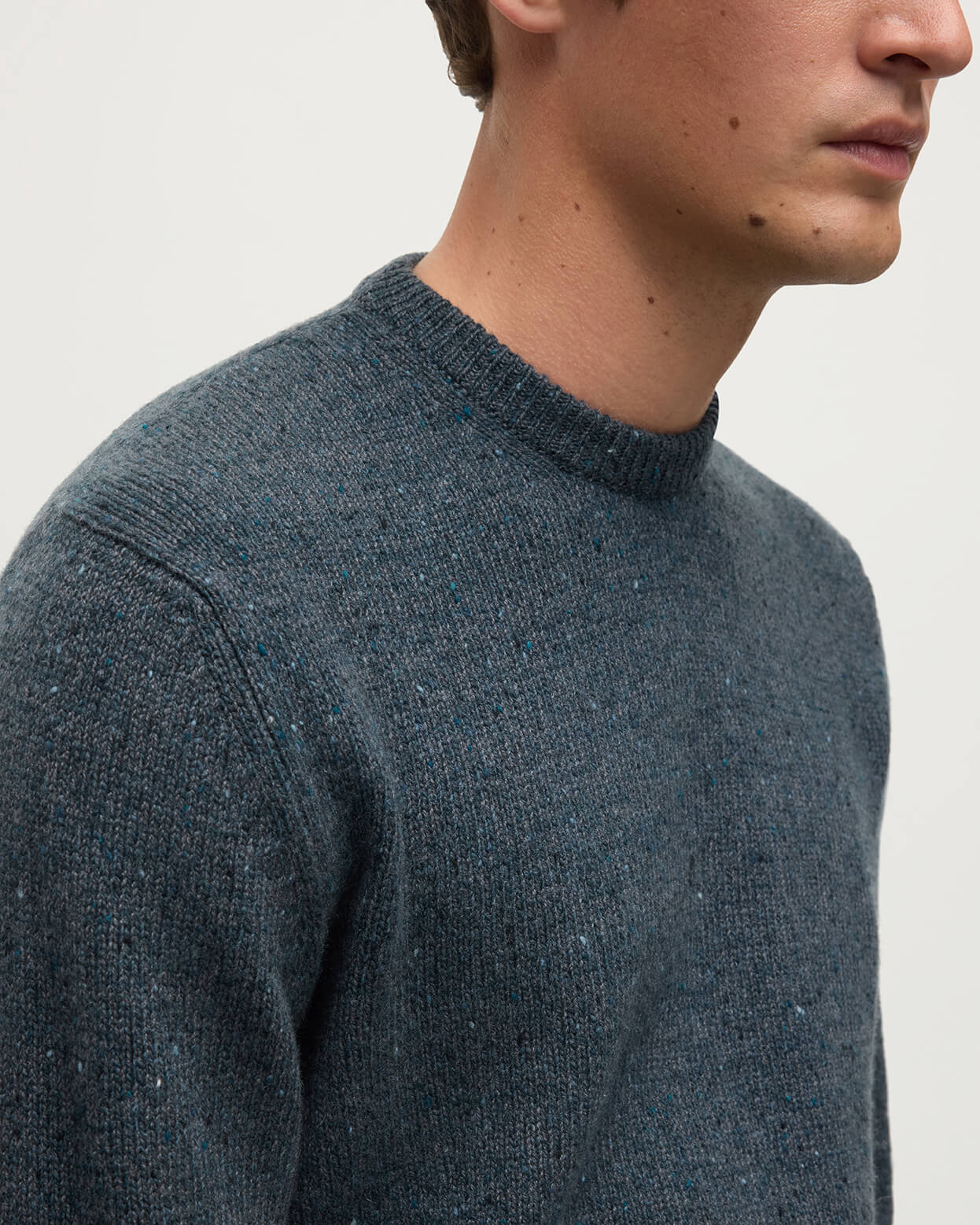 Close up view of a model wearing Johnstons of Elgin AW25 Men's Knitwear Storm Donegal Donegal Cashmere Marl Jumper KAC05287006336