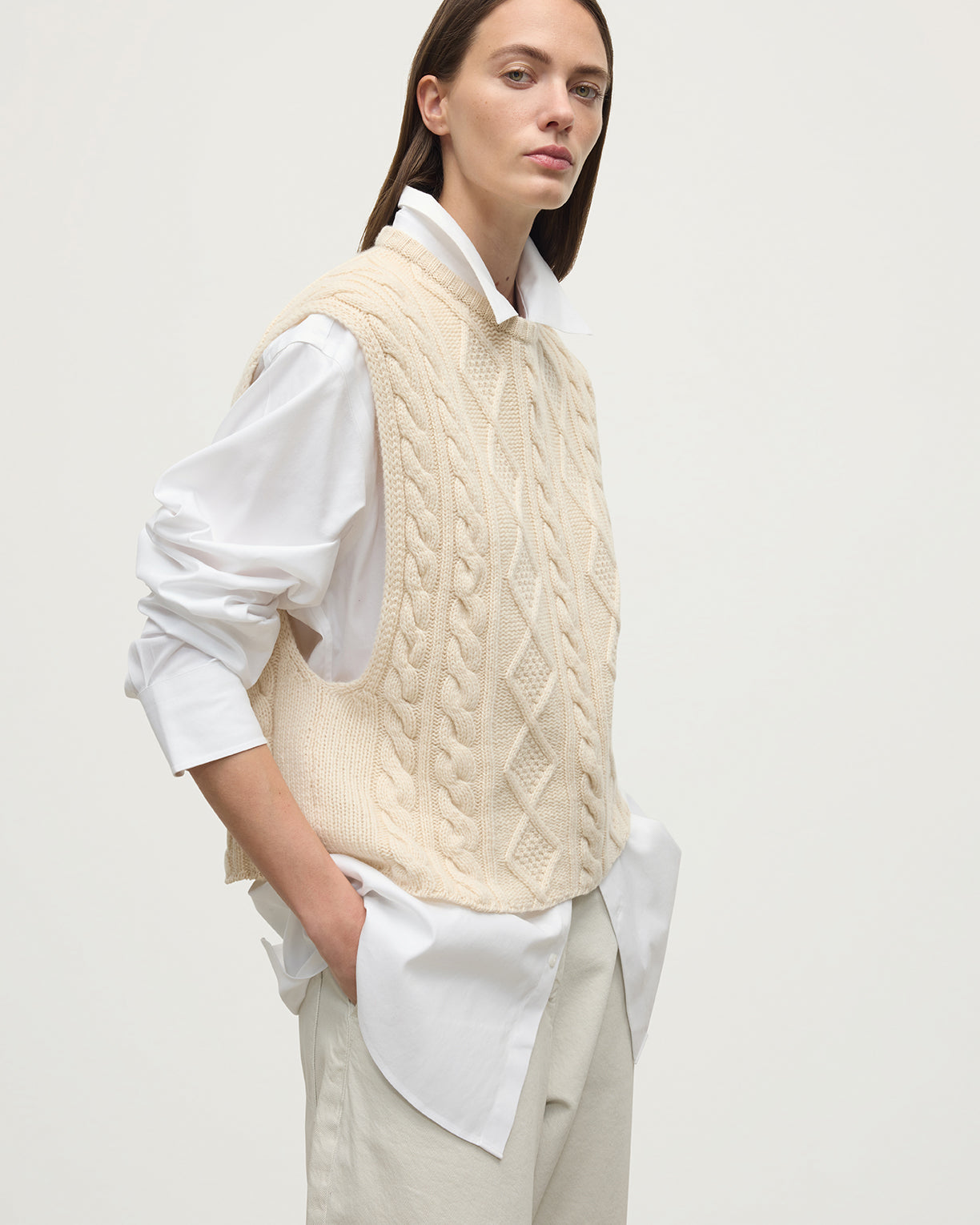 Model wears Johnstons of Elgin AW25 Women's Knitwear Champagne Aran Cable Cream Cashmere Tank Details KAC05321SA0502