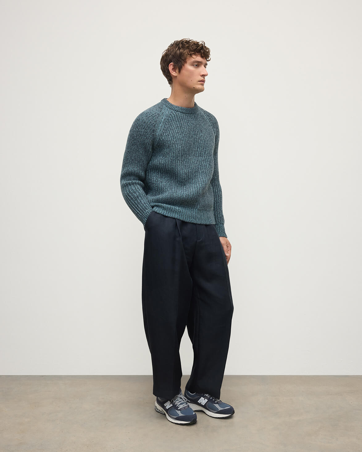 Model wears Johnstons of Elgin AW25 Men's Knitwear Storm Donegal & Seascape Ribbed Donegal Cashmere Blue Jumper Side KAC05581Q25392