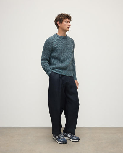 Model wears Johnstons of Elgin AW25 Men's Knitwear Storm Donegal & Seascape Ribbed Donegal Cashmere Blue Jumper Side KAC05581Q25392