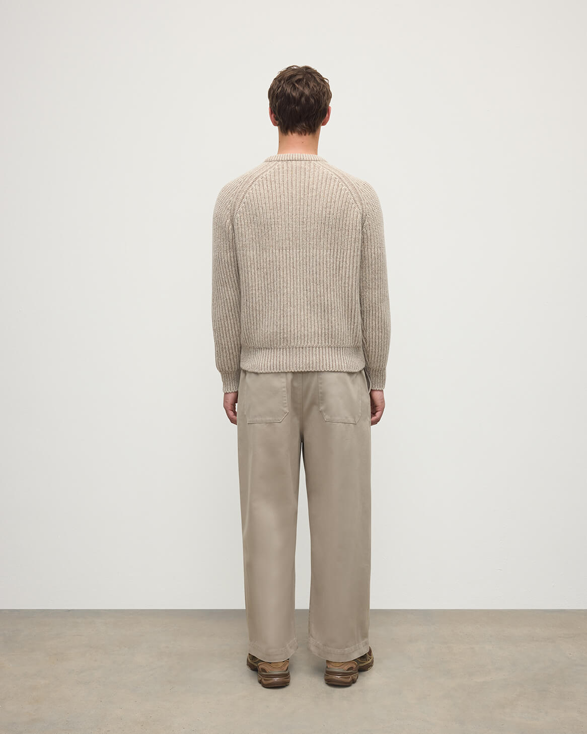 Back view of a model wearing Johnstons of Elgin AW25 Men's Knitwear Cream Dun Donegal & Ash Ribbed Donegal Cashmere Cream Jumper KAC05581Q25394