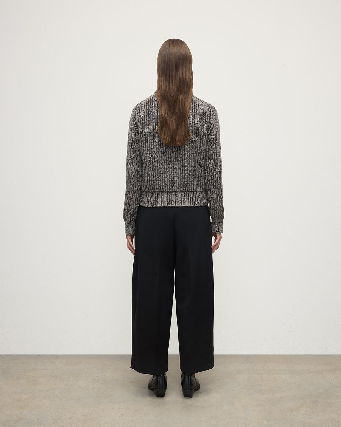 Model wearing Johnstons of Elgin AW25 Women's Knitwear Peregrine Donegal & Molasses High Neck Donegal Cashmere Brown Jumper Back View KAC05590Q25393