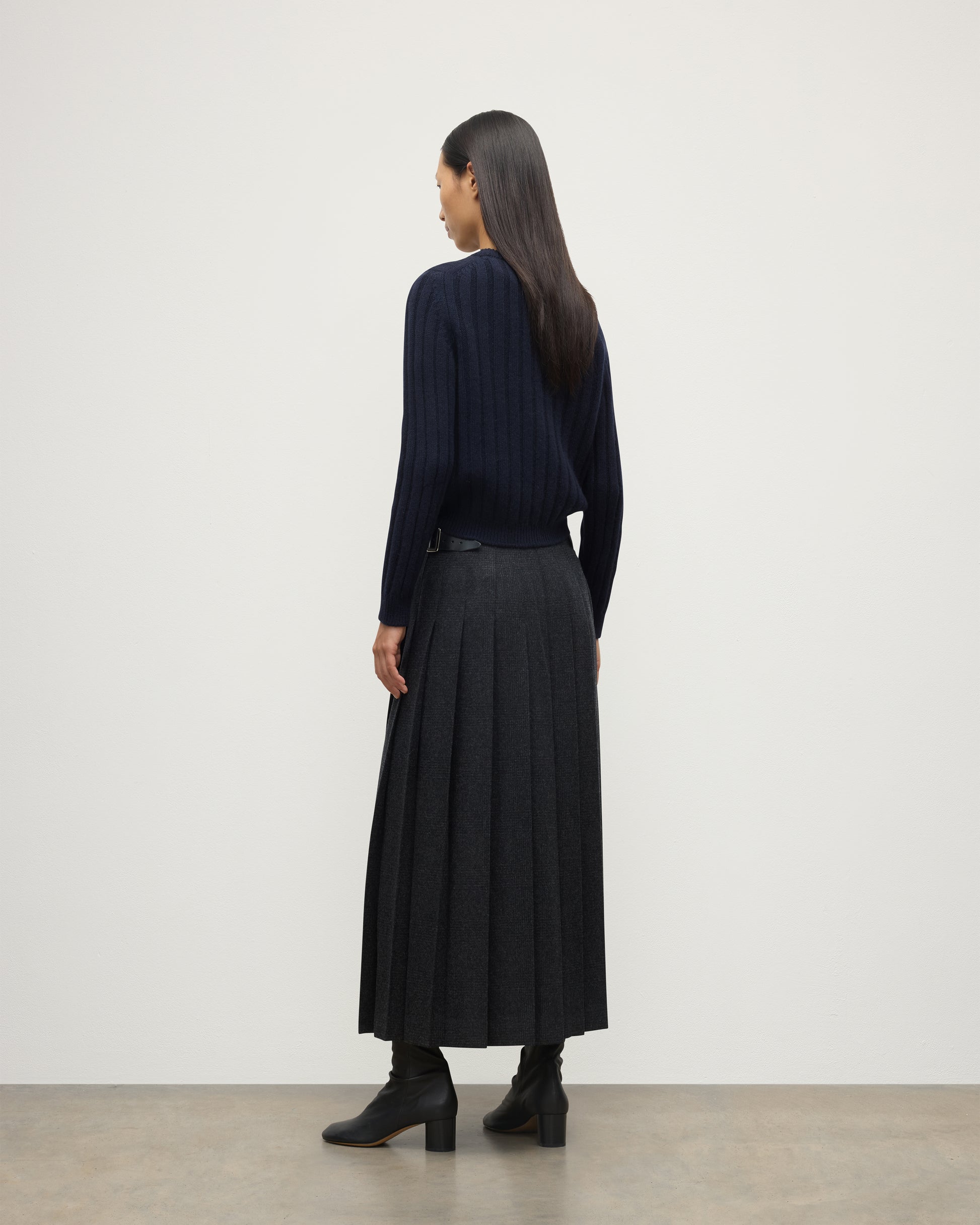 BACK OF MODEL WEARING JOHNSTONS OF ELGIN WOMENS LECHT CREW SWEATER NAVY WORN WITH LONG LE KILT CHARCOAL KILT 100% CASHMERE KAC05706SD7666