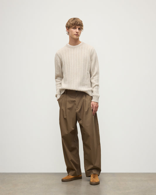 JOHNSTONS OF ELGIN MENS PEEL CREW SWEATER NATURAL 100% CASHMERE ON A MODEL OVER A WHITE T-SHIRT WITH BROWN TROUSERS KAC05751HA0402