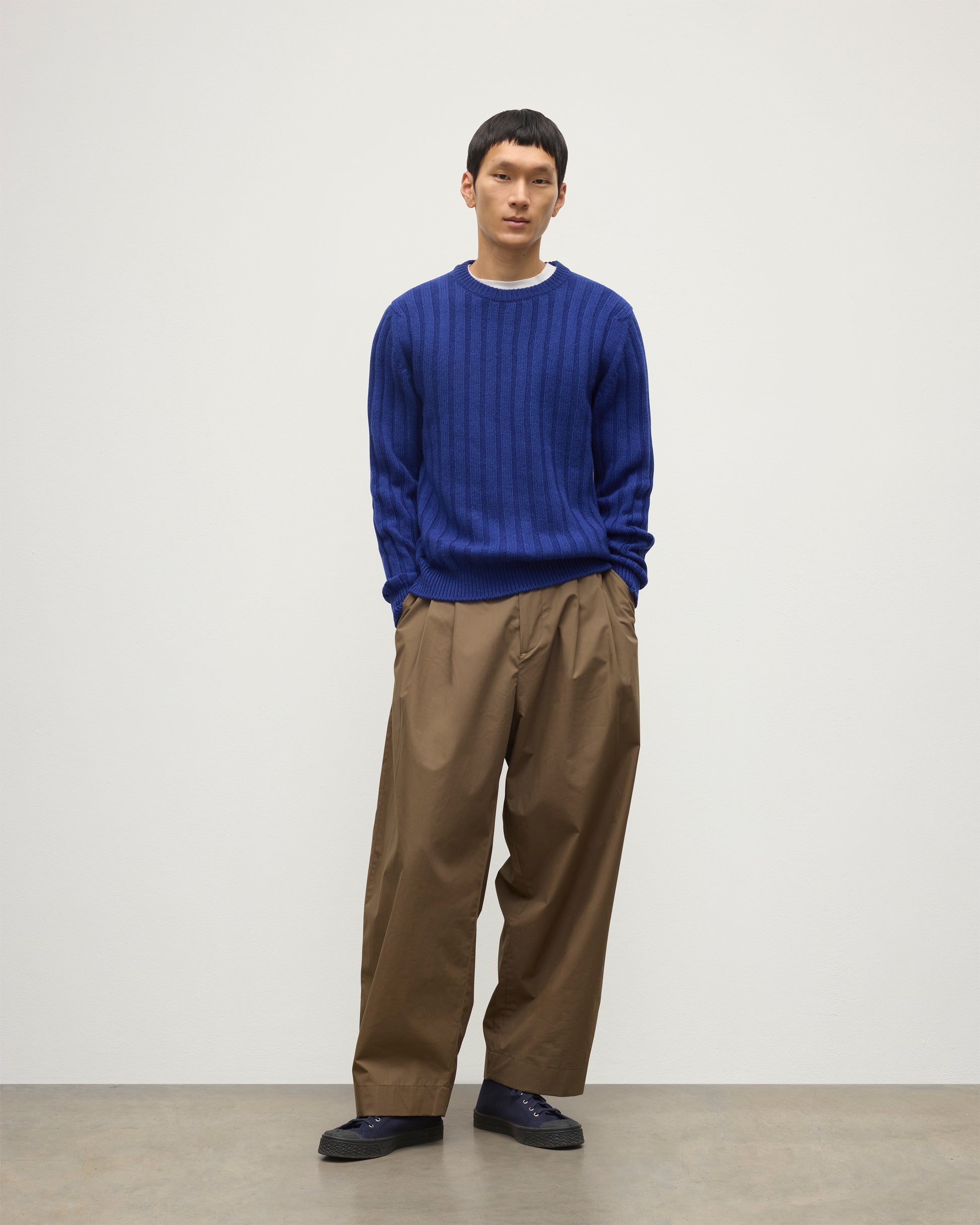 JOHNSTONS OF ELGIN MENS PEEL CREW SWEATER BLUE ON A MODEL OVER A WHITE T-SHIRT AND BROWN TROUSERS KAC05751SD5326