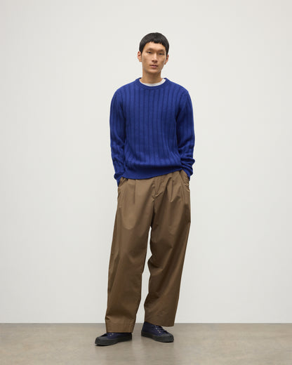 JOHNSTONS OF ELGIN MENS PEEL CREW SWEATER BLUE ON A MODEL OVER A WHITE T-SHIRT AND BROWN TROUSERS KAC05751SD5326