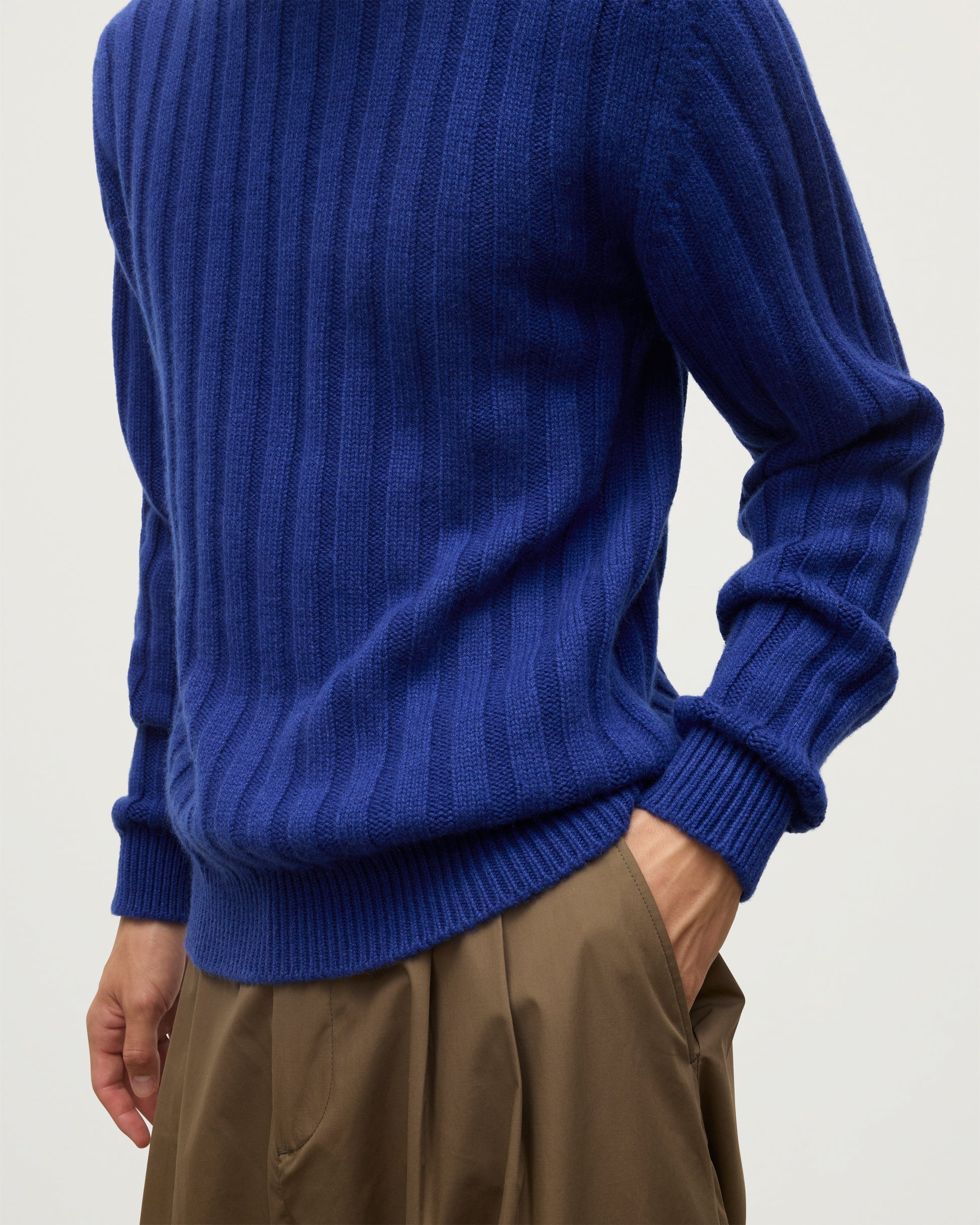 JOHNSTONS OF ELGIN MENS PEEL CREW SWEATER BLUE ON A MODEL WITH BROWN TROUSERS KAC05751SD5326
