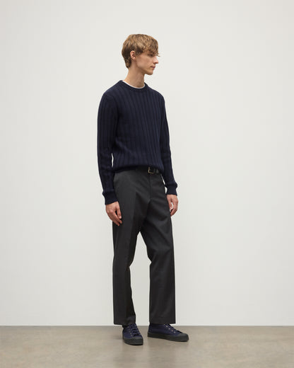 MODEL WEARS JOHNSTONS OF ELGIN MENS PEEL CREW SWEATER NAVY OVER A WHITE T-SHIRT WITH GREY TROUSERS KAC05751SD7666