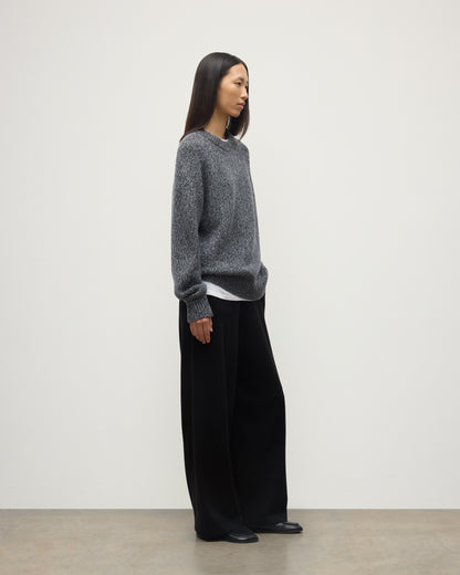 SIDE VIEW OF FEMALE MODEL WEARS JOHNSTONS OF ELGIN FYFE CREW SWEATER NAVY 100% CASHMERE WITH BLACK TROUSERS UAC05753006876