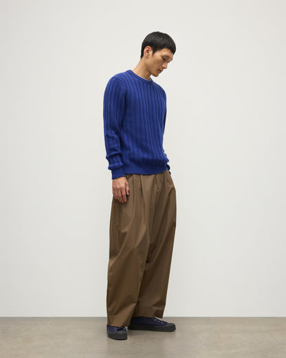 JOHNSTONS OF ELGIN MENS PEEL CREW SWEATER BLUE ON A MODEL OVER A WHITE T-SHIRT AND BROWN TROUSERS KAC05751SD5326