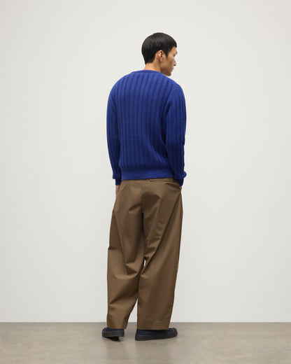 JOHNSTONS OF ELGIN MENS PEEL CREW SWEATER BLUE ON A MODEL OVER A WHITE T-SHIRT AND BROWN TROUSERS KAC05751SD5326