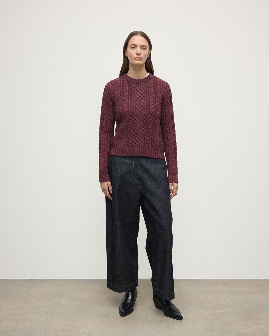 Model wears Johnstons of Elgin AW25 Women's Knitwear Damson Aran Cable Purple Cashmere Jumper  Front View KAI05086HE7064