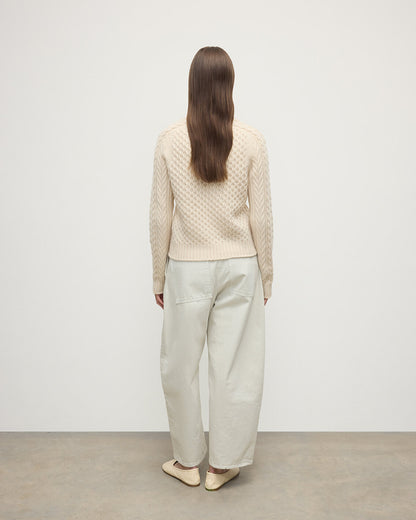 Model wearing Johnstons of Elgin AW25 Women's Knitwear Champagne Aran Cable Cream Cashmere Jumper Back View KAI05086SA0502