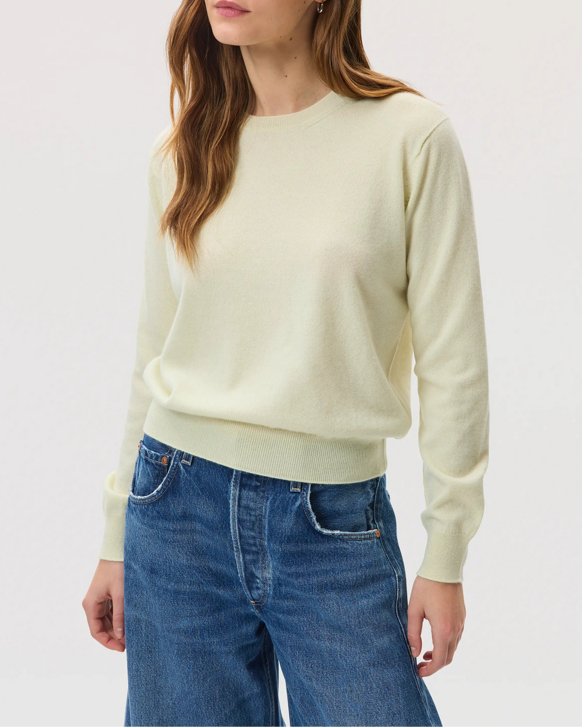 Model wearing Johnstons of Elgin SS25 Women's Knitwear Lemon Classic Cashmere Round Neck sweater on a white backdrop KAI05142SA0145