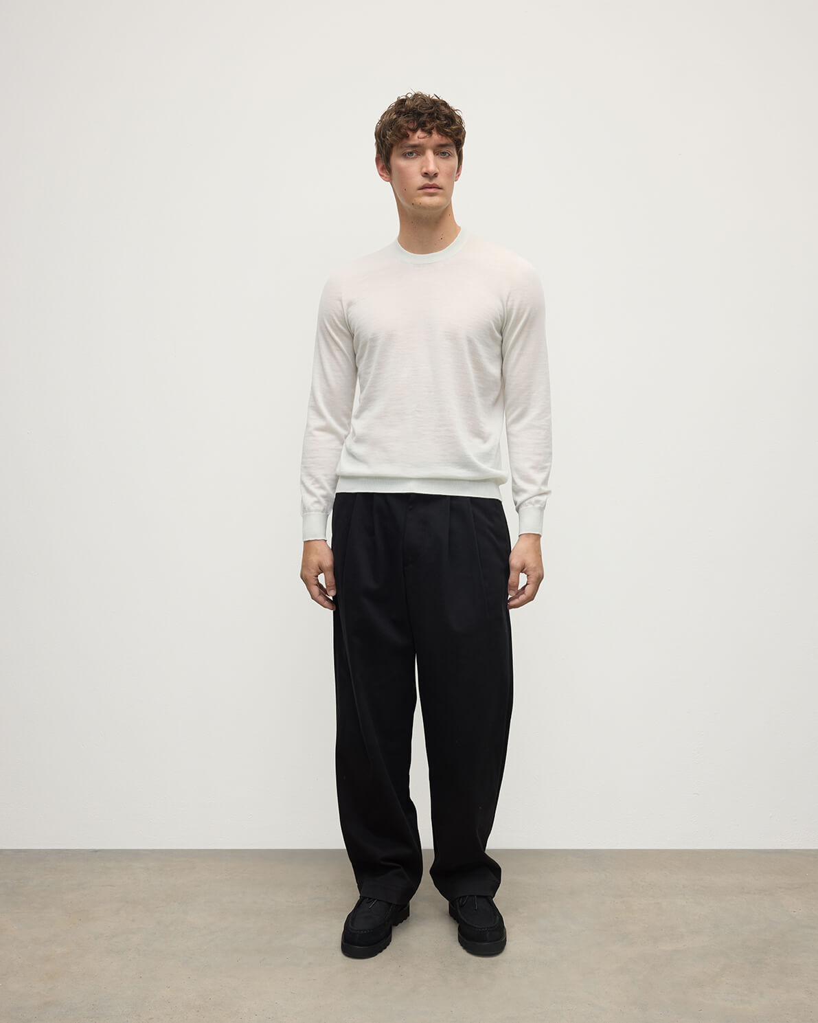 model wearing Johnstons of Elgin AW25 Men's Knitwear White Superfine Cashmere V Neck Jumper  against a white backdrop  KAI05242HA0327