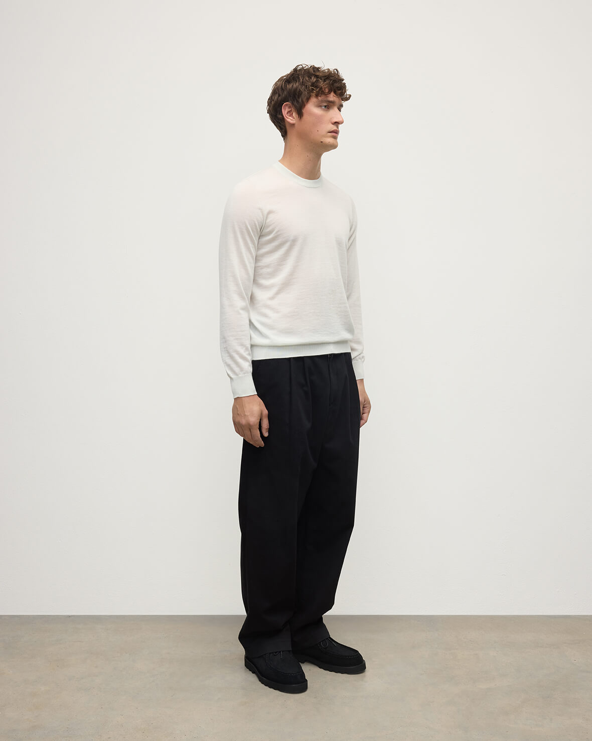 model wearing Johnstons of Elgin AW25 Men's Knitwear White Superfine Cashmere V Neck Jumper  against a white backdrop  KAI05242HA0327