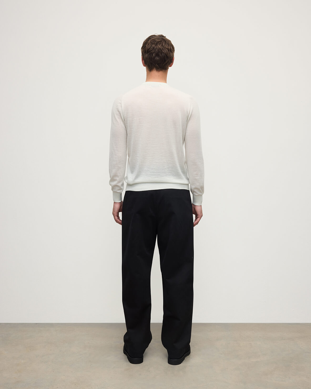 model wearing Johnstons of Elgin AW25 Men's Knitwear White Superfine Cashmere V Neck Jumper  against a white backdrop  KAI05242HA0327