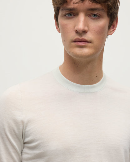 model wearing Johnstons of Elgin AW25 Men's Knitwear White Superfine Cashmere V Neck Jumper  against a white backdrop  KAI05242HA0327