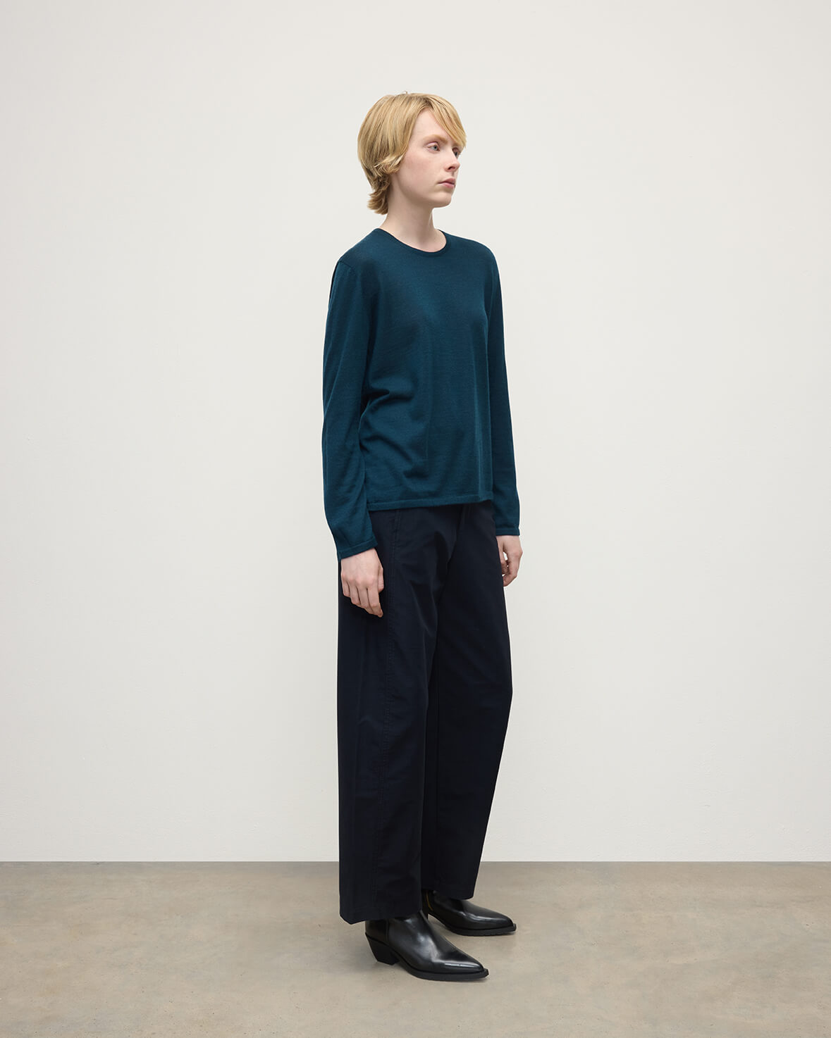Model wearing Johnstons of Elgin AW25 Women's Knitwear Bottle Green Superfine Cashmere Green Jumper Side View KAI05318SC7344