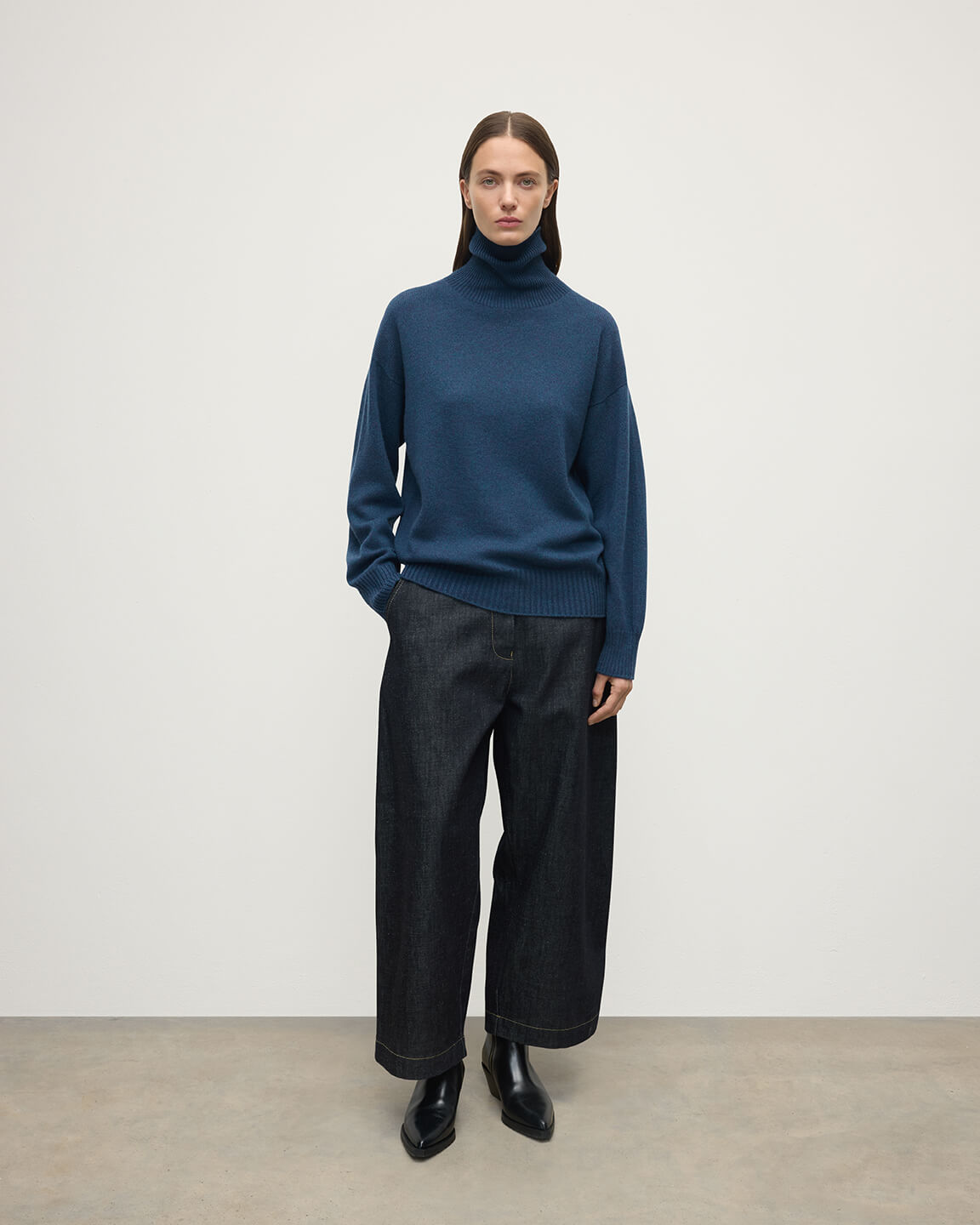 Model wears Johnstons of Elgin AW25 Women's Knitwear Heather Navy Gauzy Cashmere Roll Neck Front View KAI05324HD7321